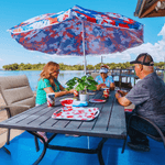 two women and a man playing cards at a table at a Panama City rv park