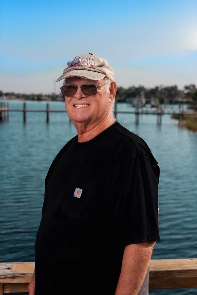 camp host mr steve on the pier overlooking the water at rv park in panama city fl